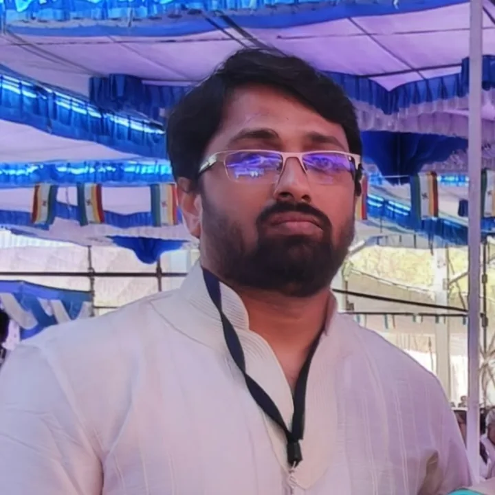 Pavan at an event with a lanyard