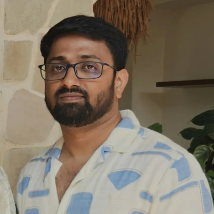 Pavan in a patterned shirt, smiling softly